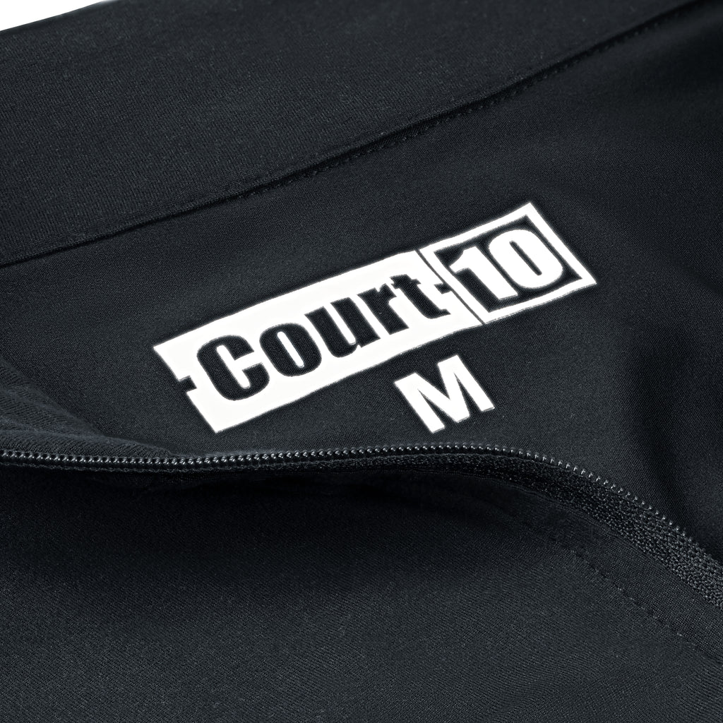 Open zip neckline detail with 'Court10' logo and size 'M' on black Performance Long Sleeve