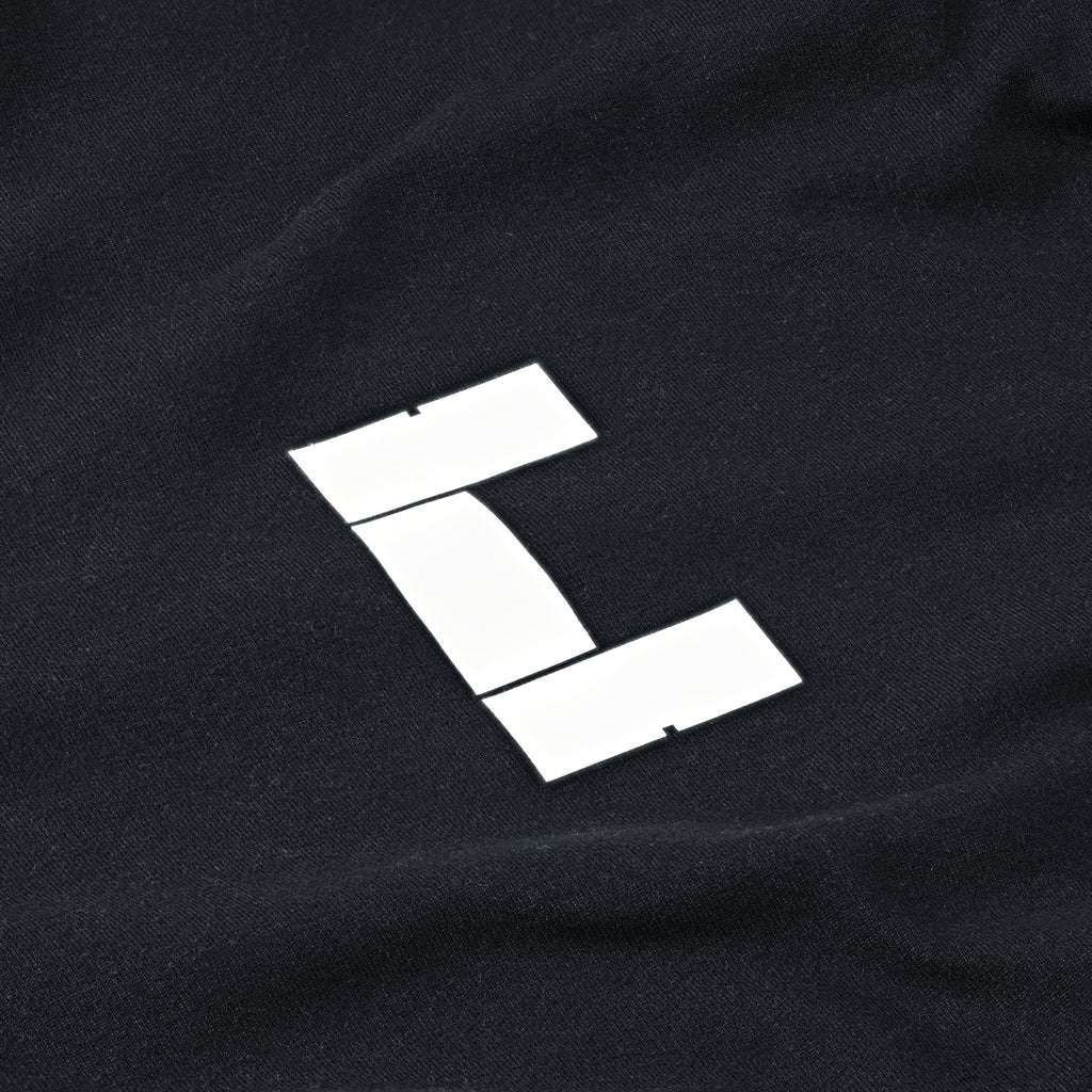 White logo detail of black Performance Long Sleeve