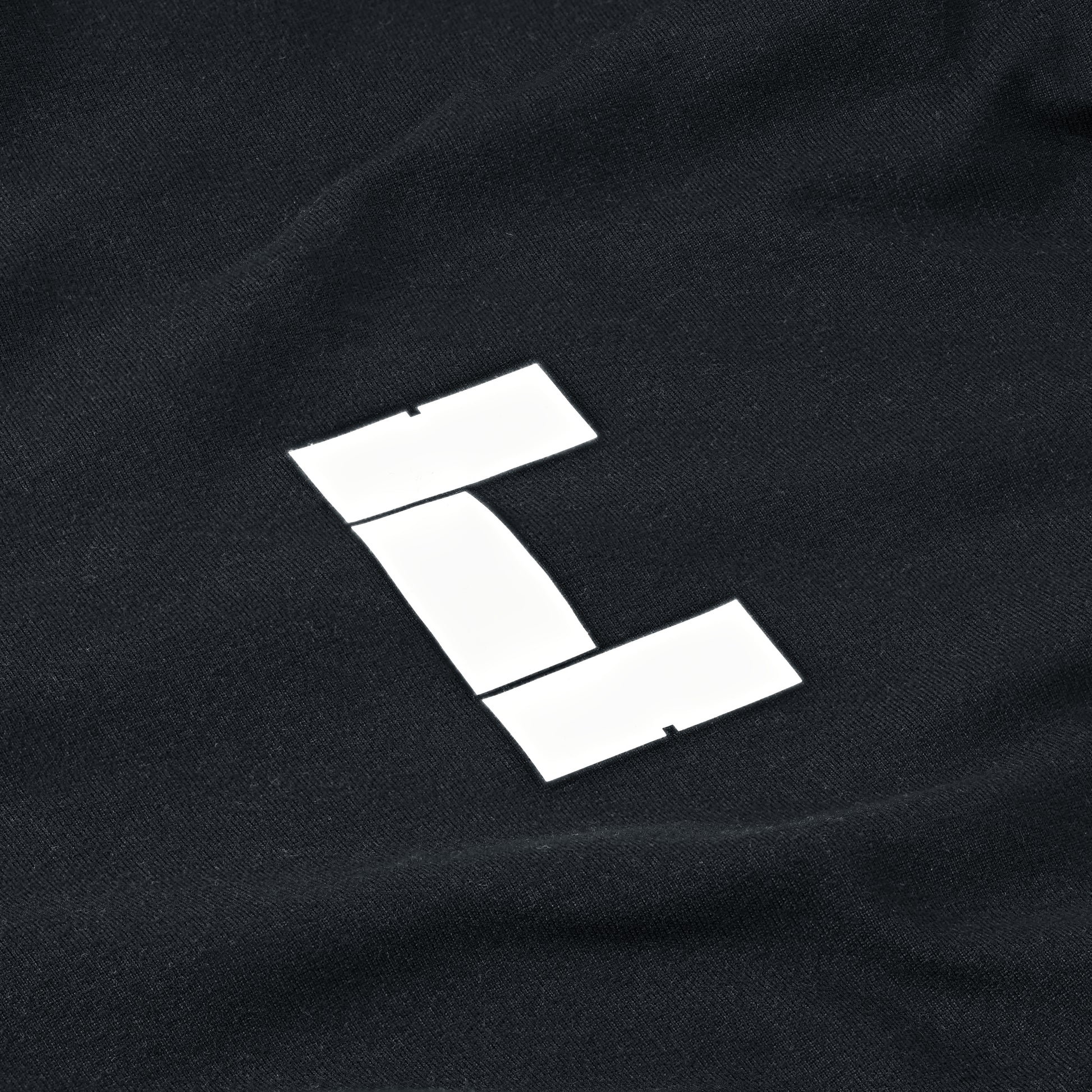 White logo detail of black Performance Long Sleeve