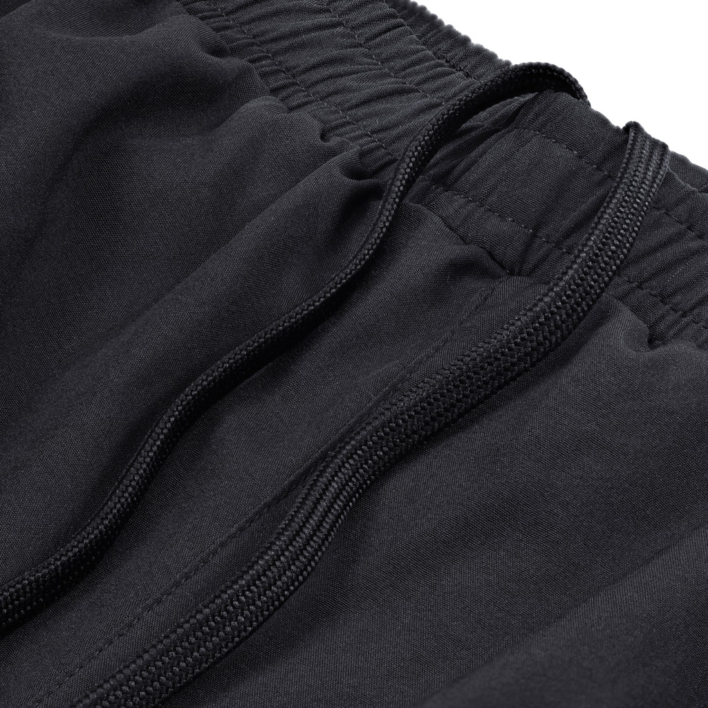 Close-up of black Court10 Performance Shorts with drawstring detail on a white background